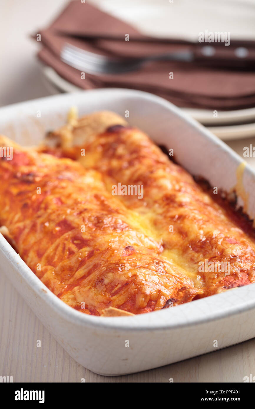 Two enchiladas in a baking dish Stock Photo