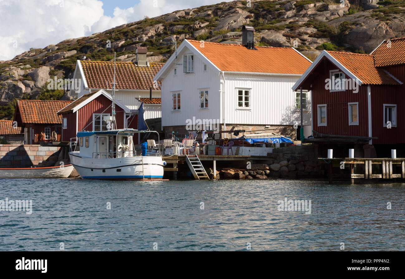 Small harbor with boat and boathouses Stock Photo