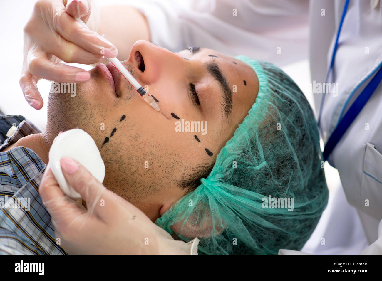 Plastic surgeon preparing for operation on man face Stock Photo - Alamy