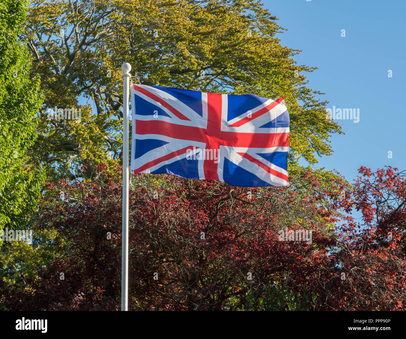 Union Jack or Union Flag flying in strong wind Stock Photo