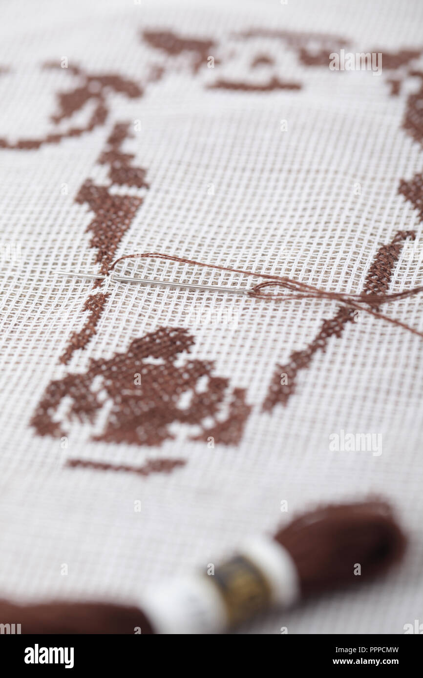 Needle and thread in embroidery closeup Stock Photo - Alamy