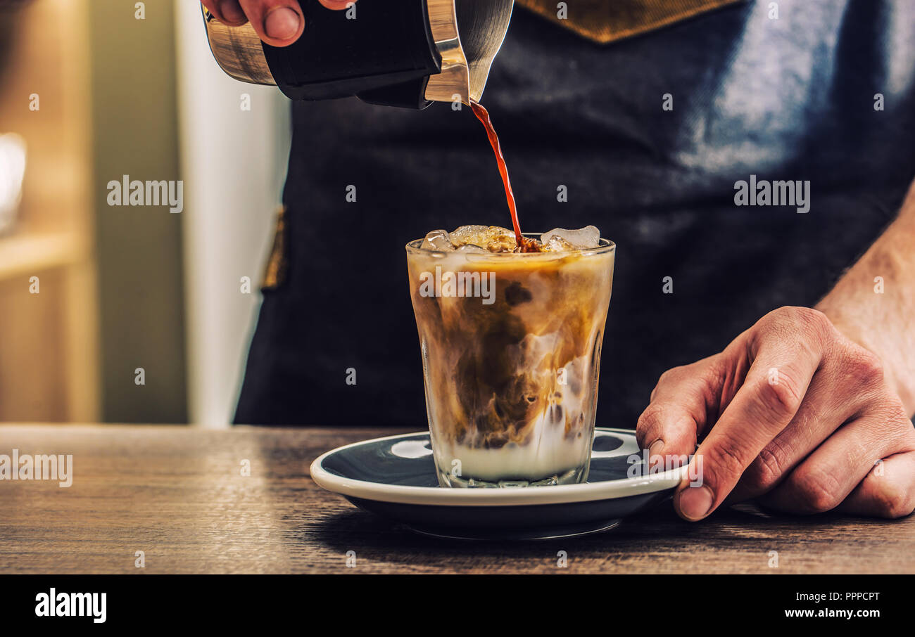Close-up a barista making fres ice coffee on barcounter. Stock Photo