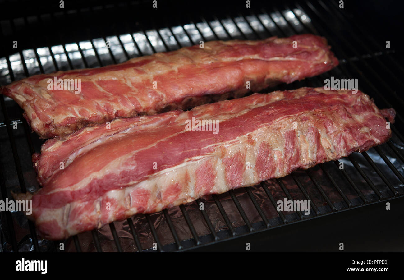 Racks of pork ribs cooking on the barbque Stock Photo Alamy