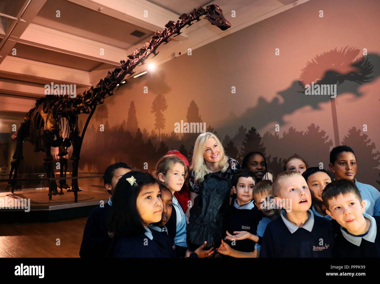 Pupils from Botanic Primary school with Dippy, The Natural History Museum's Diplodocus skeleton cast, during a media preview in the Ulster Museum, Belfast, ahead of it opening to the public on Friday as part of the UK tour. Stock Photo