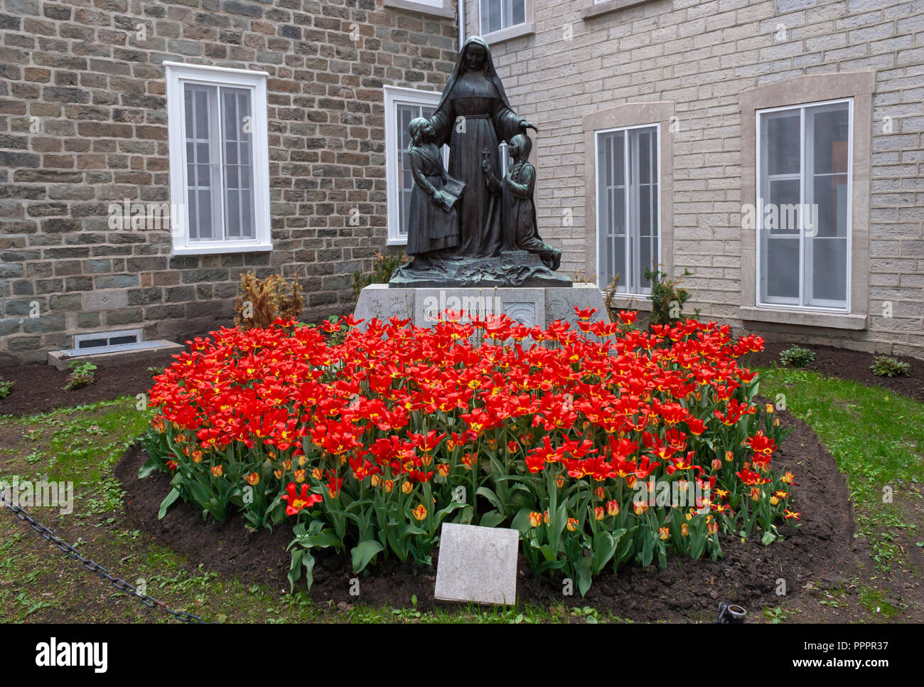The statue of the Saint Marie of the Incarnation, the foundress of the Ursuline Order in Canada, in front of the Ursulines School in Quebec City. Stock Photo