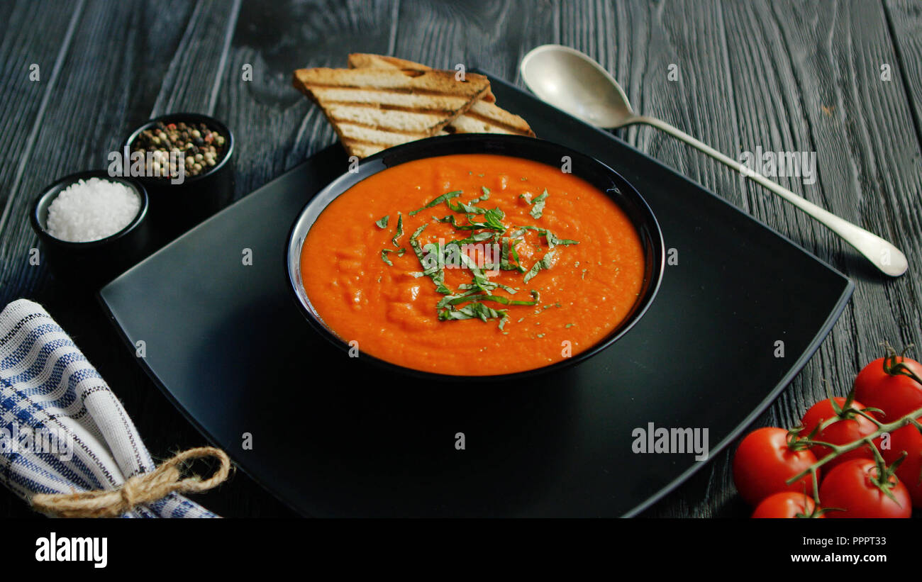 Tomato soup in bowl with crisp bread Stock Photo