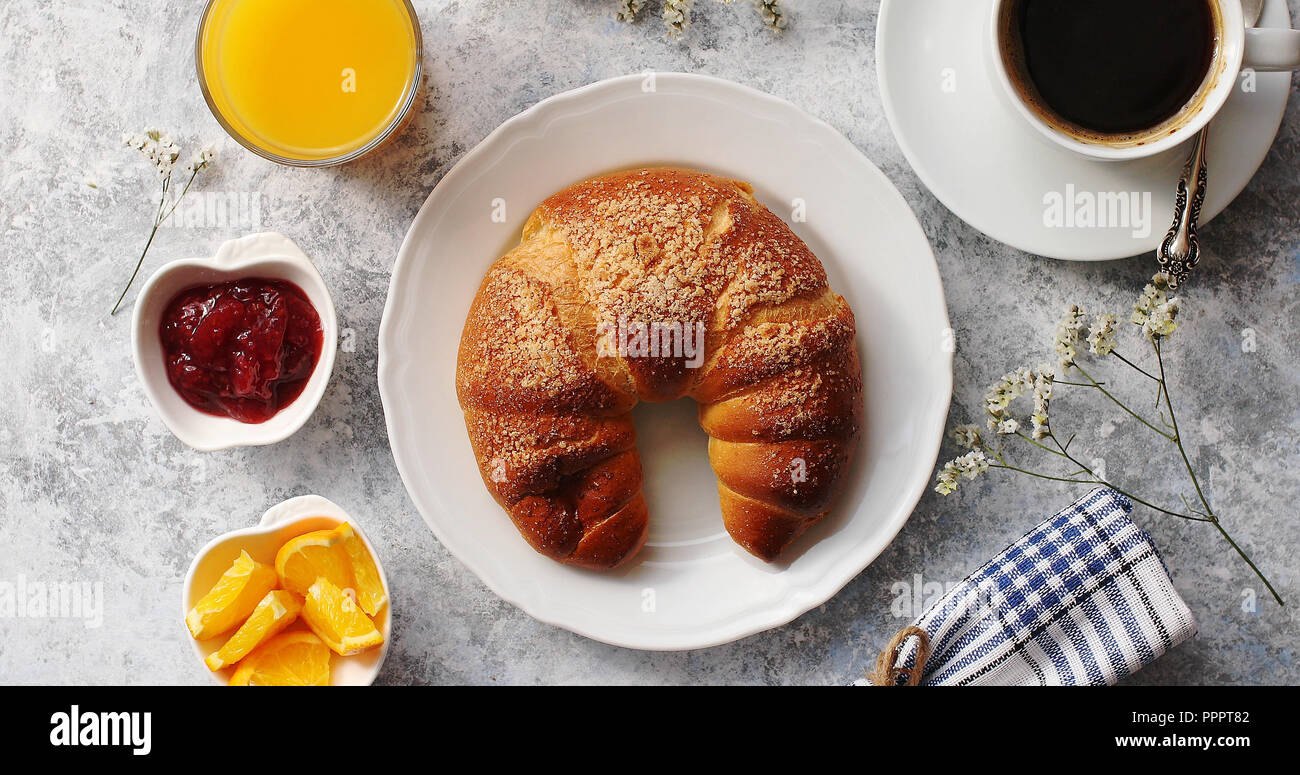 Baked croissant with drinks on table Stock Photo