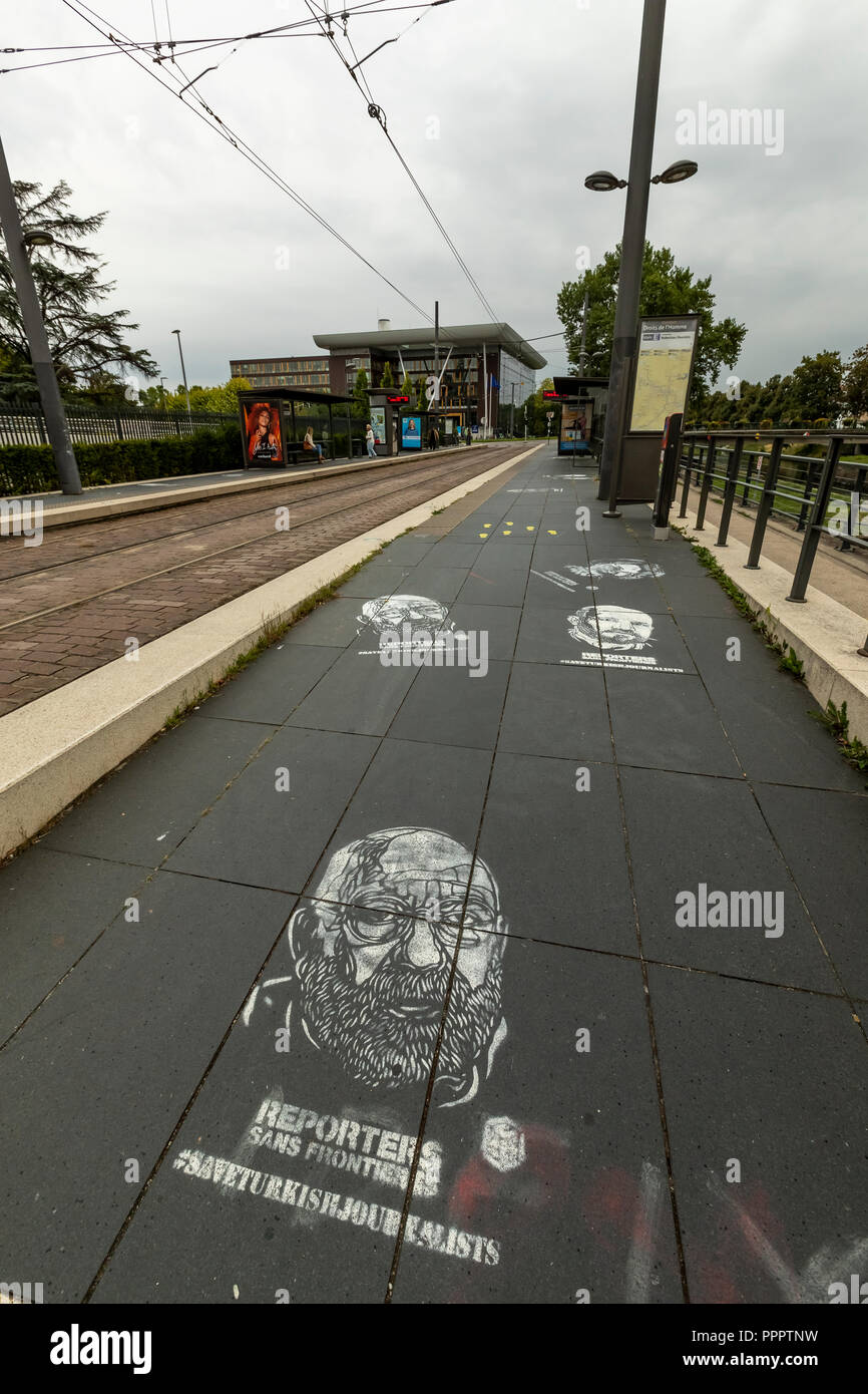 Graffiti template sprayed onto the pavement protests the rights of Turkish journalists. ECHR, Strasbourg, France Stock Photo