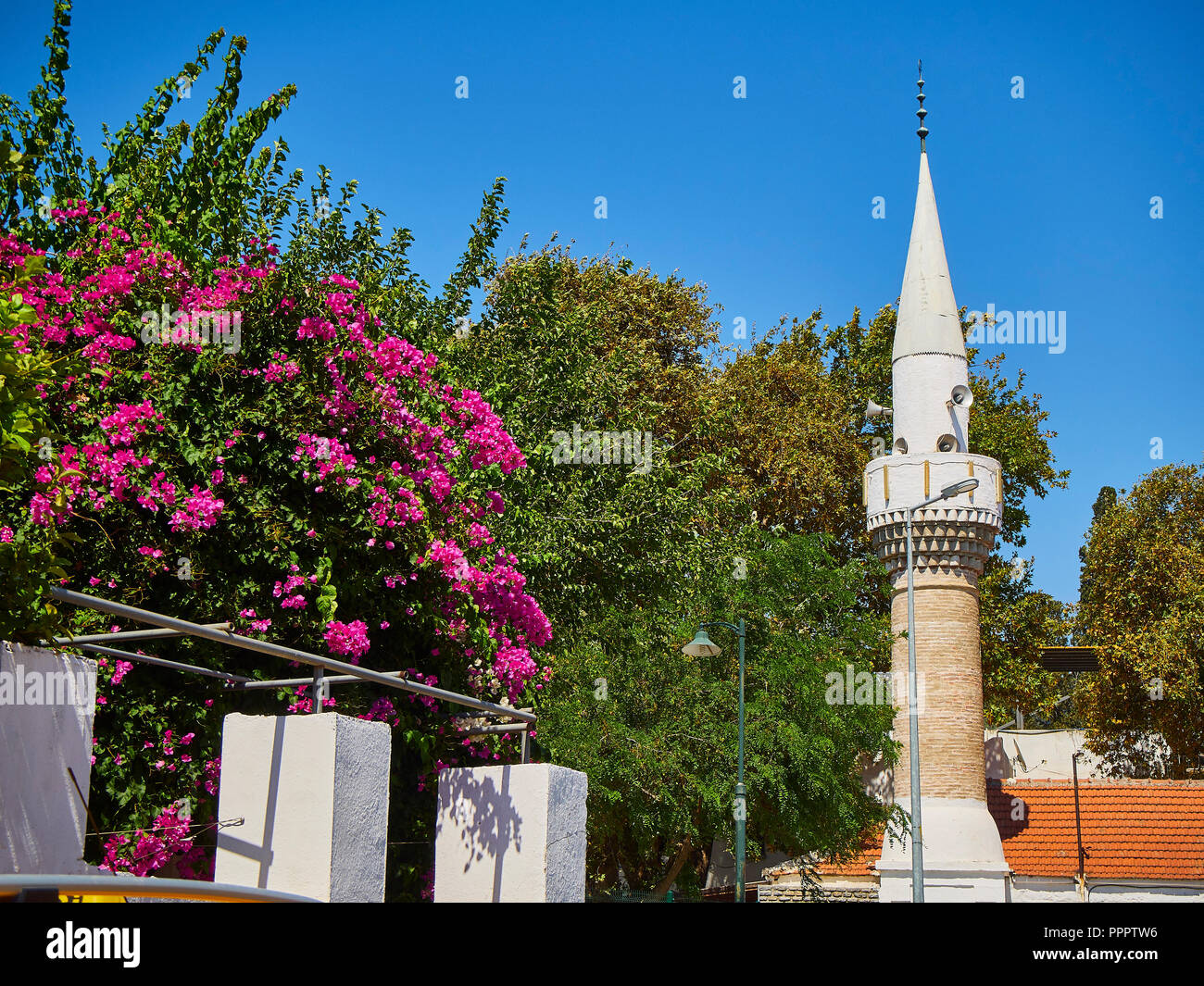 Minaret of Turkkuyusu Cami mosque, view from Turgut Reis street. Bodrum. Mugla Province, Turkey. Stock Photo