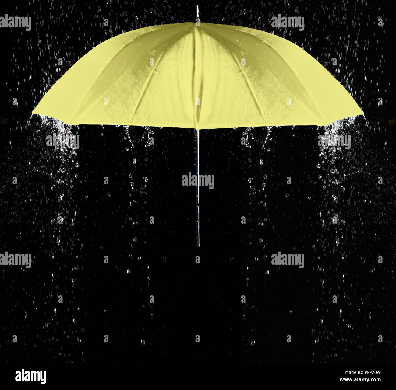 Yellow umbrella under raindrops with black background. Business and fashion concept. Stock Photo