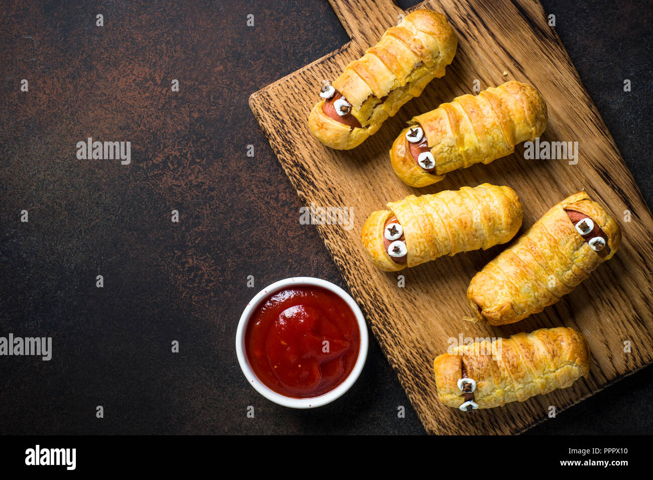Halloween food. Scary sausage mummies in dough Stock Photo - Alamy