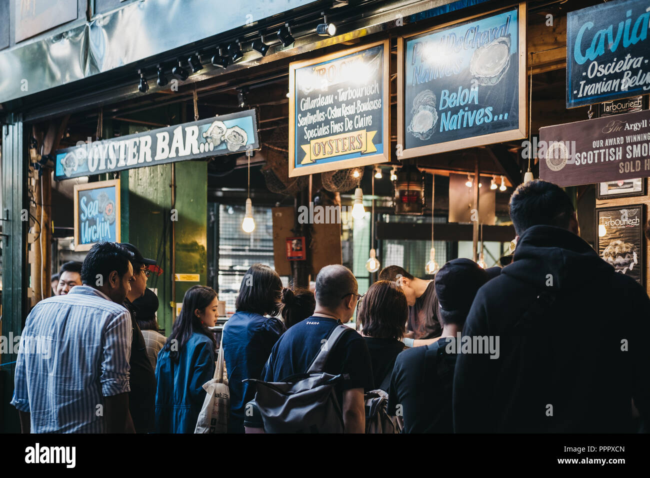 London, UK September 17, 2018 Customer queuing at an oyster bar in