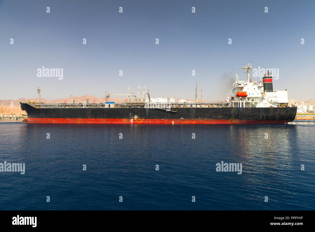 Industrial tanker ship loading in new port of Aqaba, Jordan Stock Photo