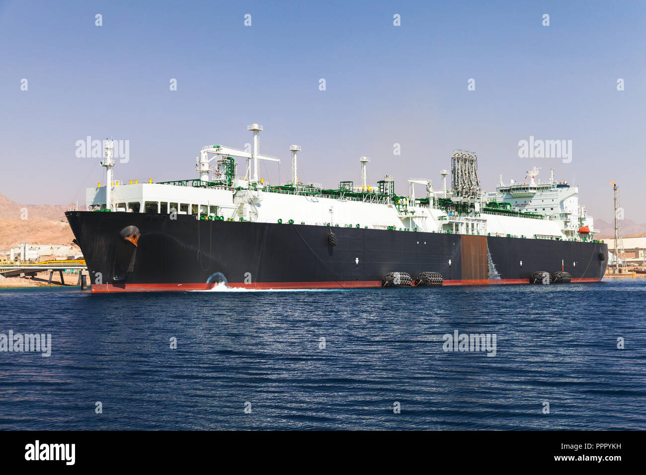 Loading of huge oil tanker in new port of Aqaba, Jordan Stock Photo