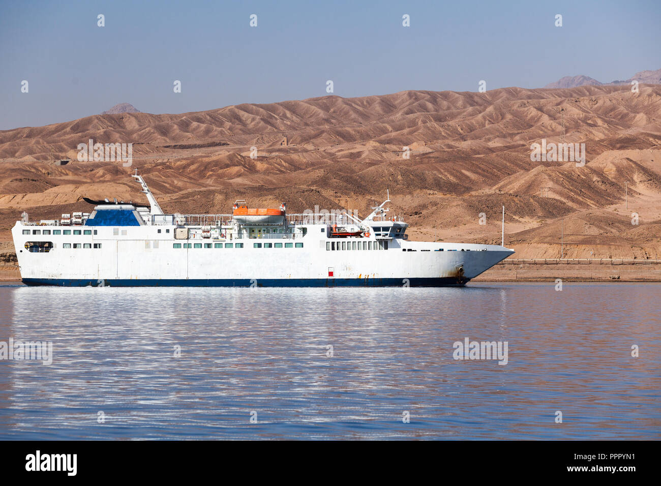 White passenger ferry enters Aqaba port, Red Sea, Jordan Stock Photo