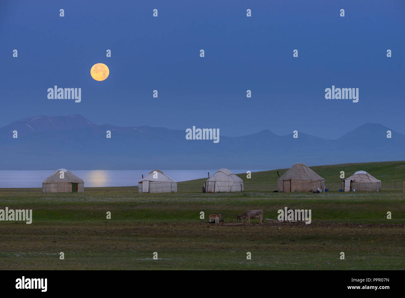 Moon rising over Song Kol lake and nomads Yurts, Naryn province, Kyrgyzstan, Central Asia Stock Photo