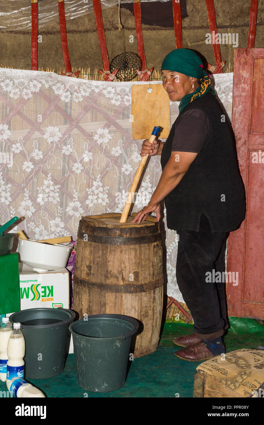 Kyrgyz woman mixing kumis during the fermentation process, Song Kol Lake, Naryn province, Kyrgyzstan, Central Asia Stock Photo