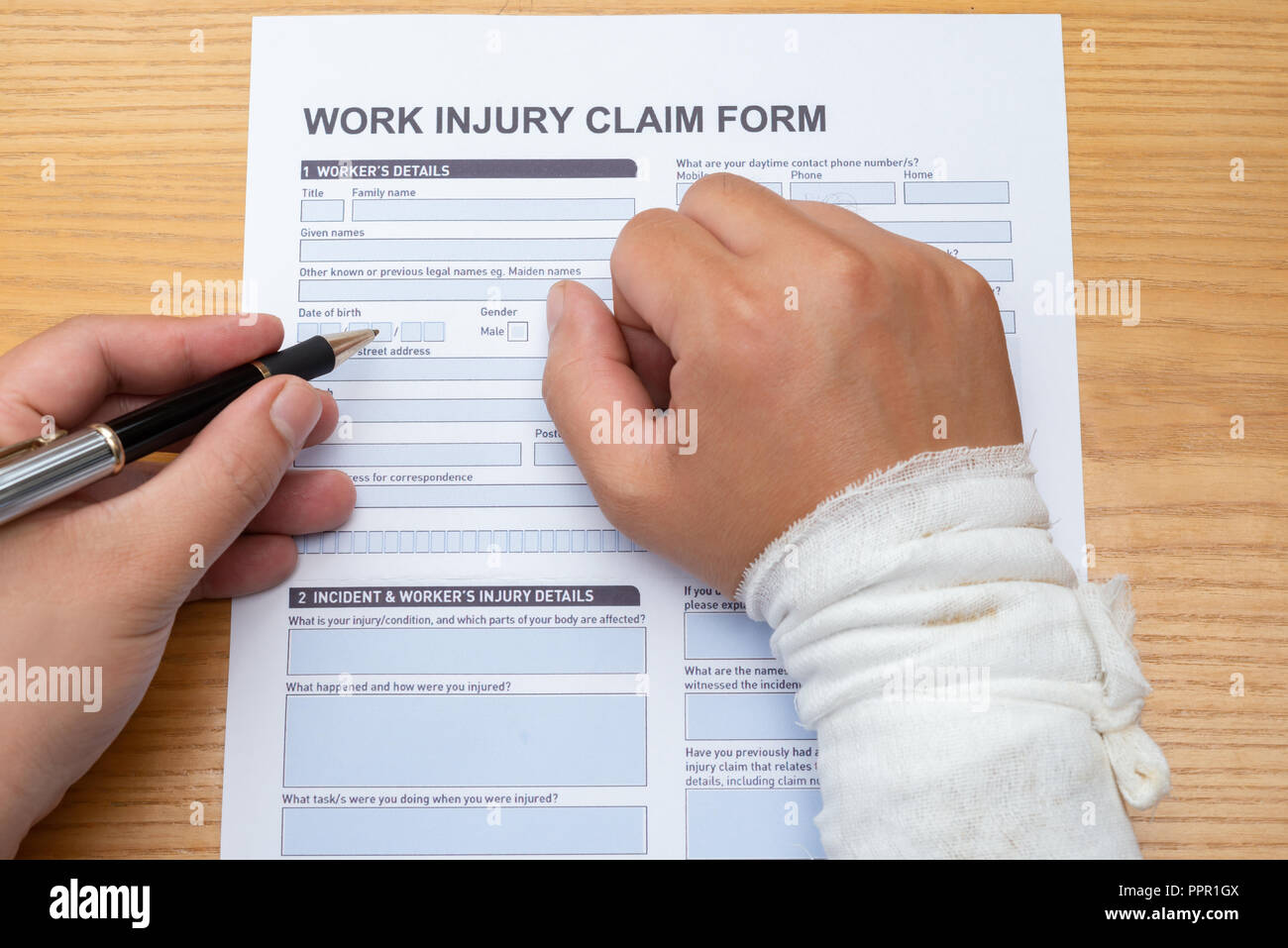 injury up claim filling a form wrapped ... work hand with a
