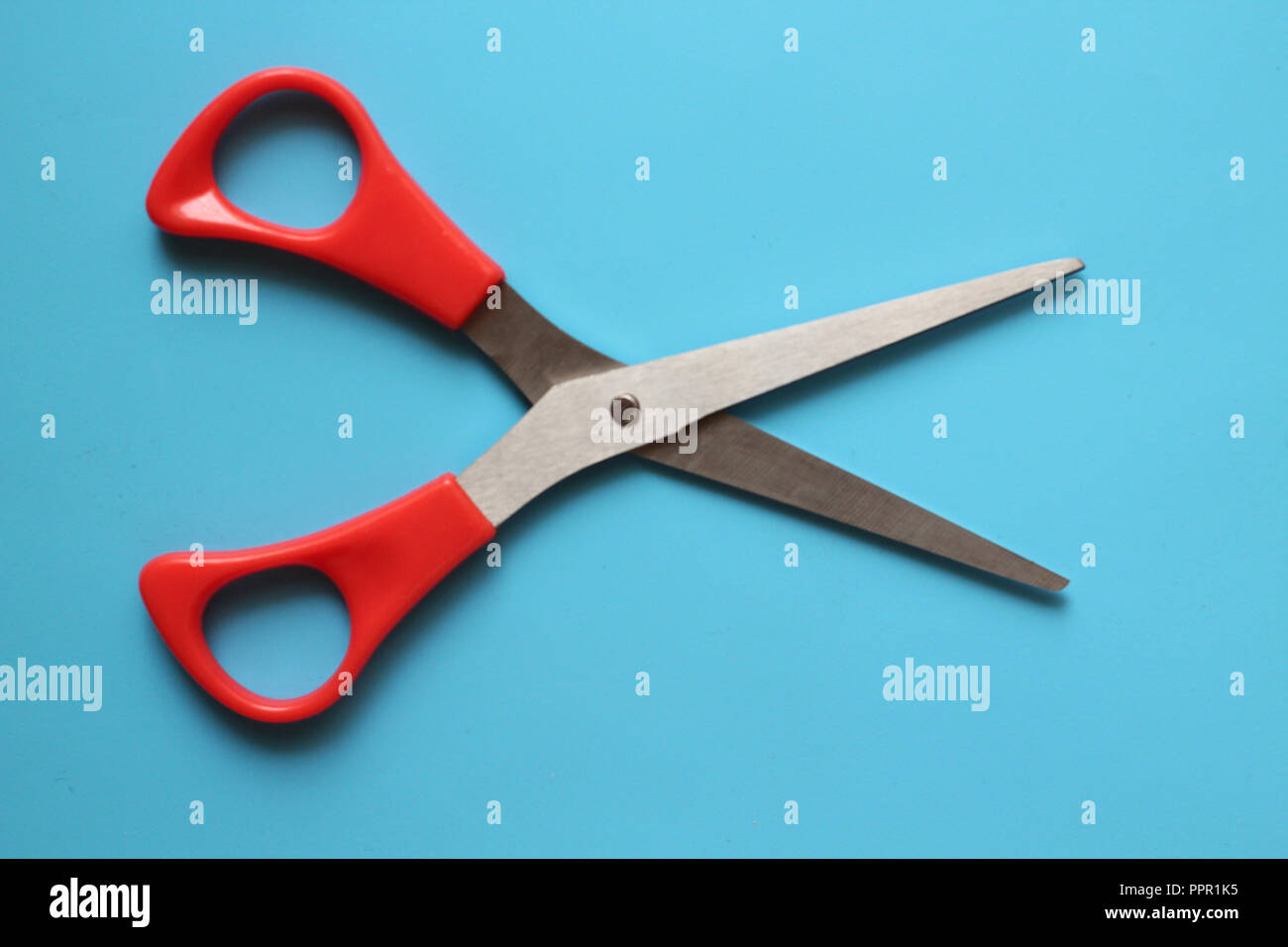 variations of layouts of stationery items, scissors on a colored ...