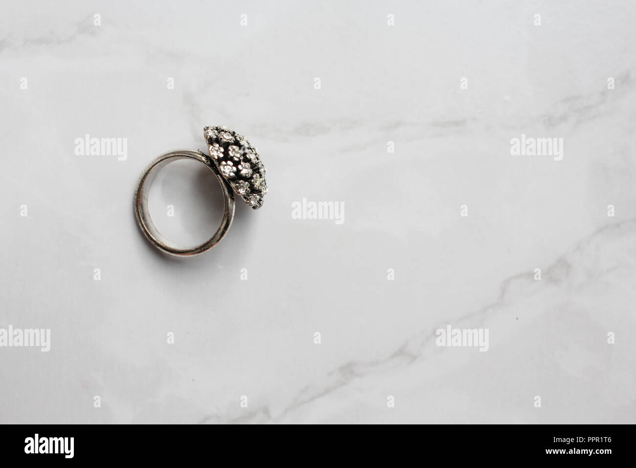 silver ring with precious stones on the marble background Stock Photo