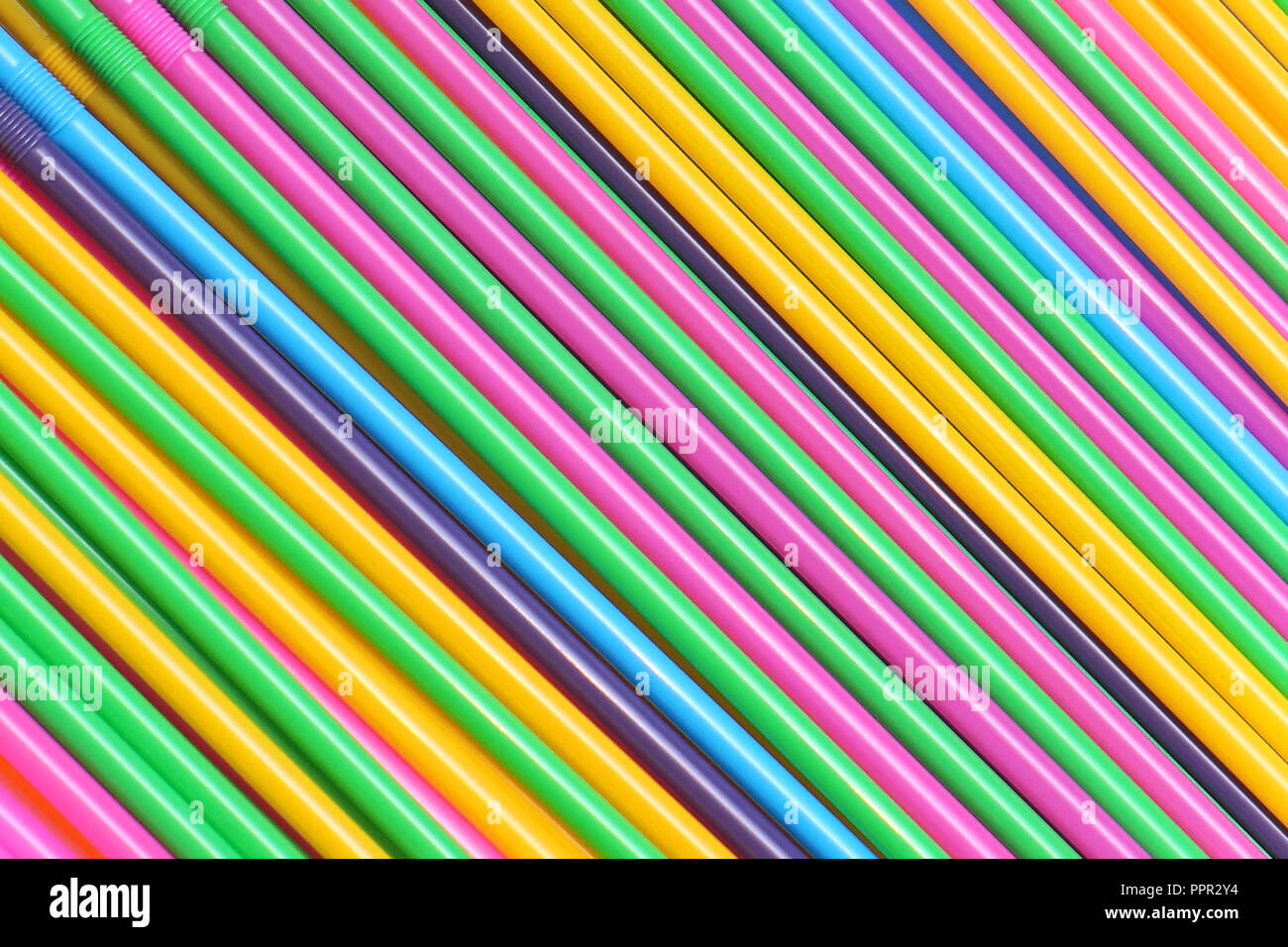 Colorful plastic drinking straws in diagonal pattern background Stock Photo