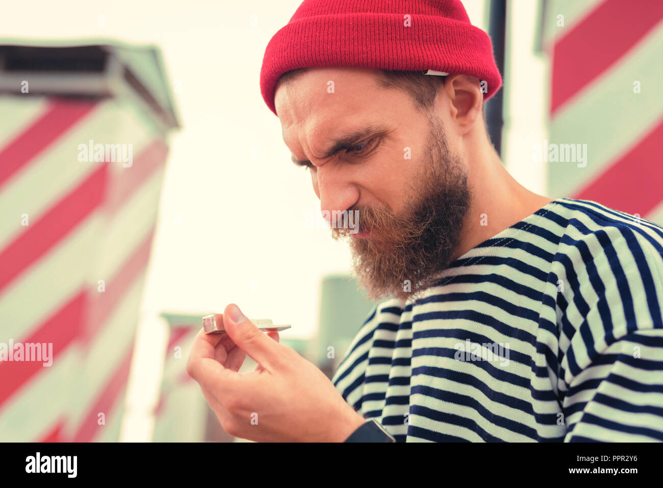 Addicted man frowning and hating his awful smoking habit Stock Photo