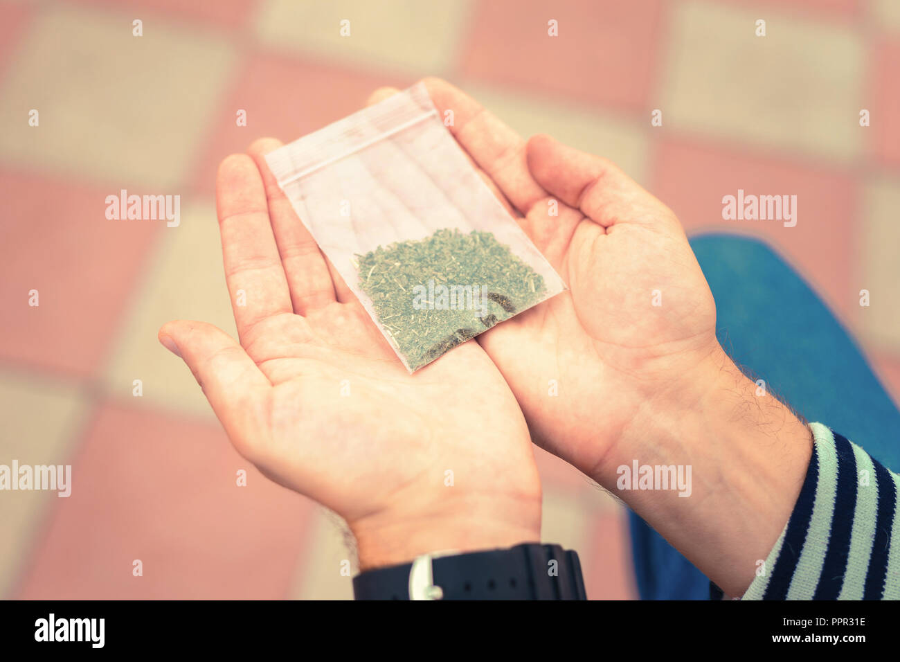 Close up of tobacco package placed on the hands of man Stock Photo