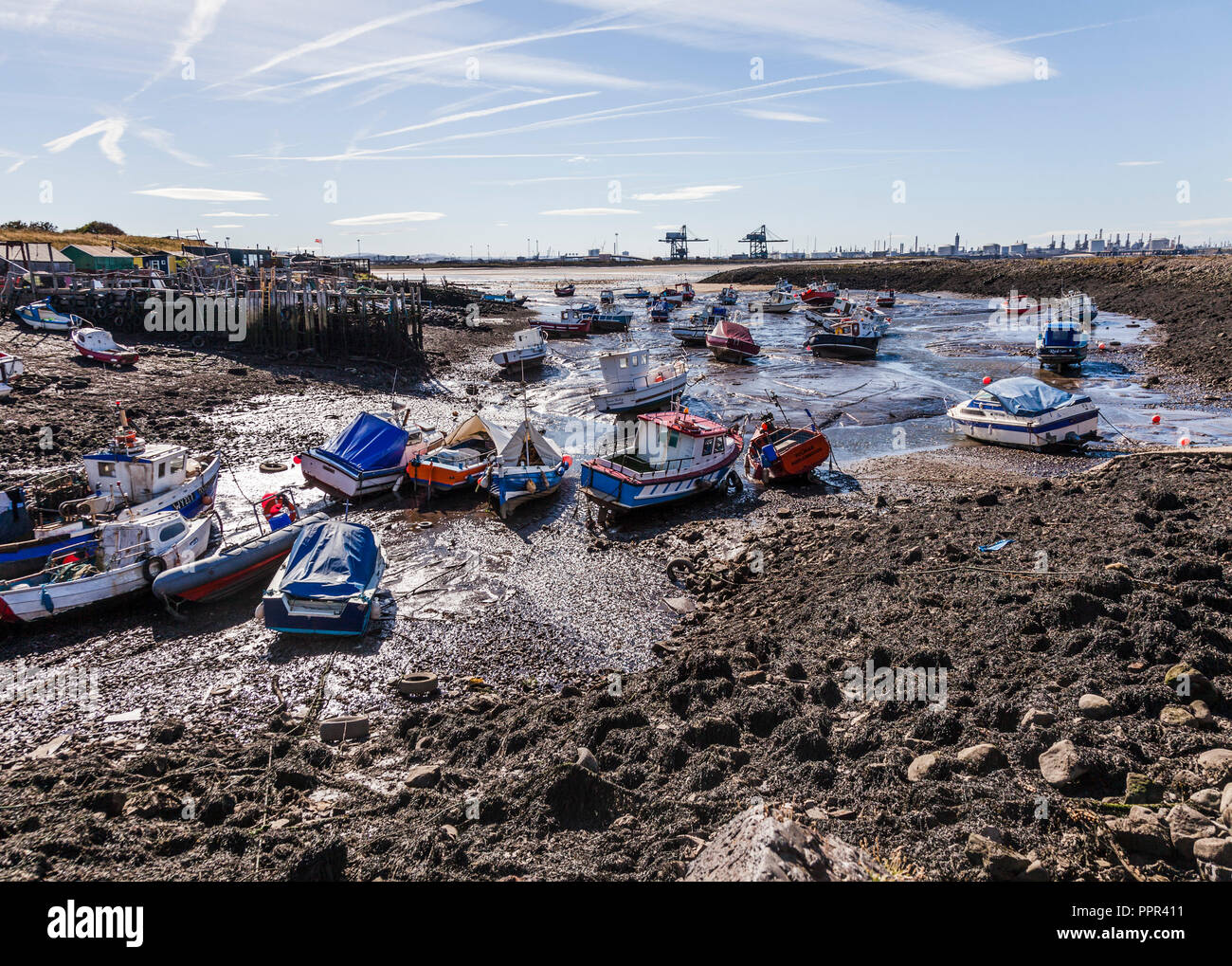 The boats moored at low tide in the small harbour at Paddys Hole,South