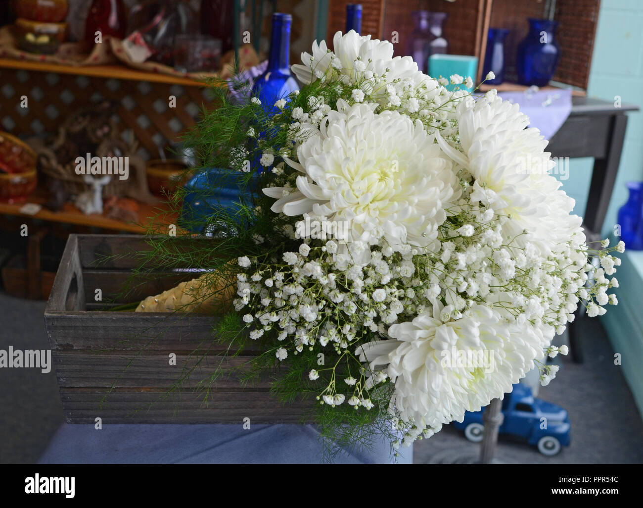 Closeup of a nosegay-style bridal bouquet with babies breath, delphinium, cushion mums. Stock Photo