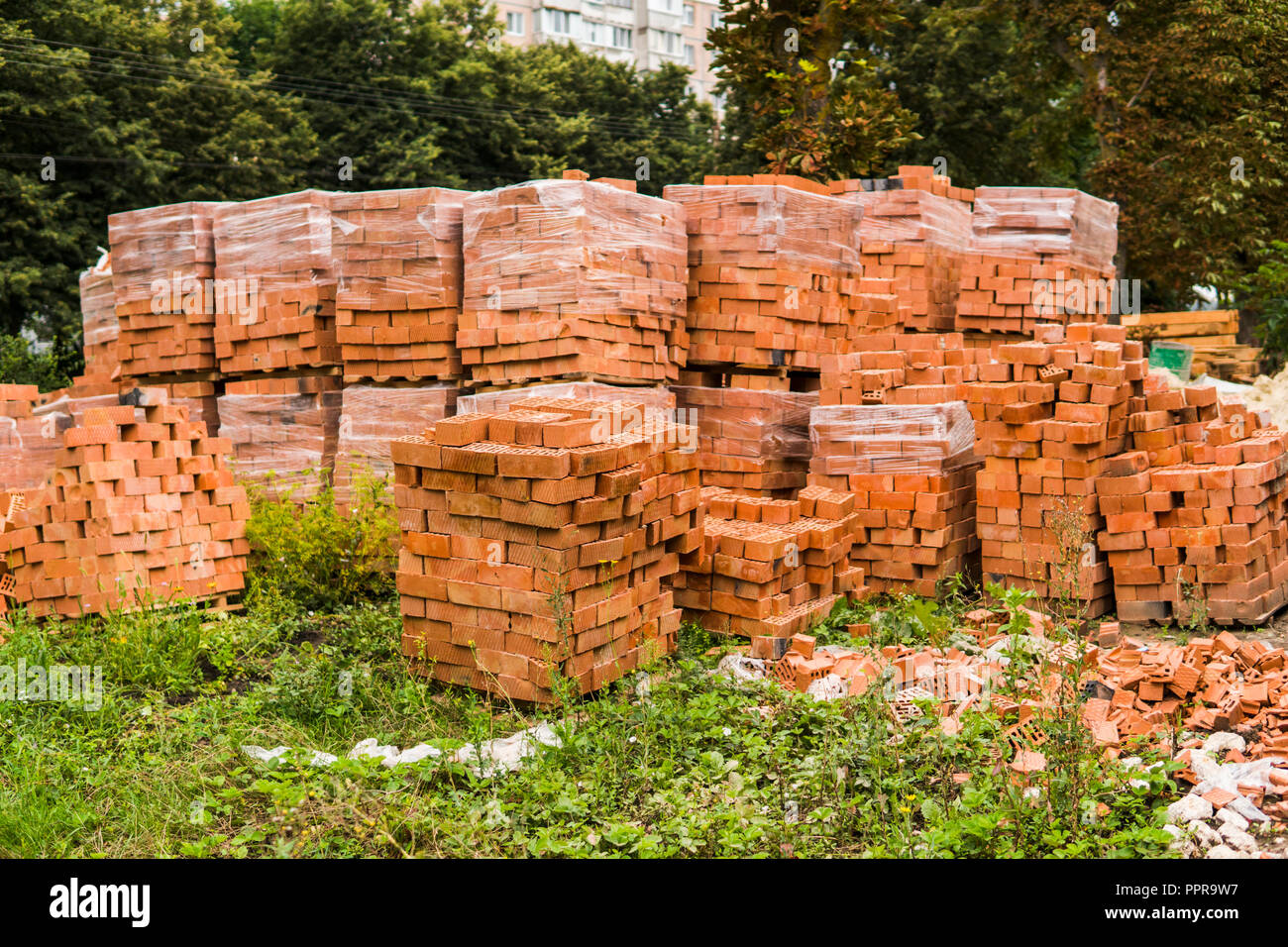 Stack of red brick for construction. Common quality building bricks