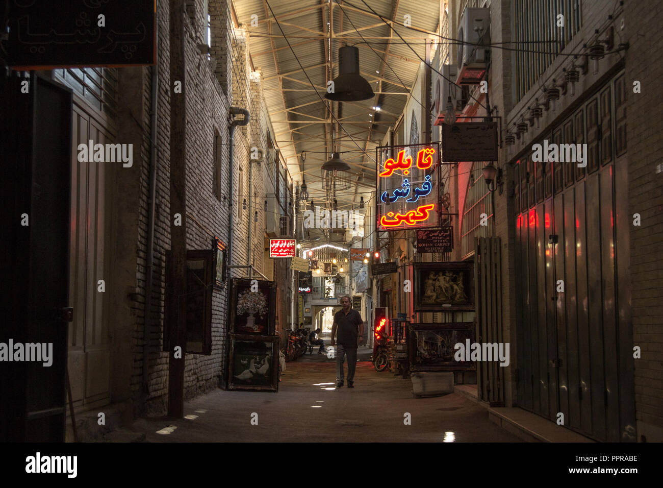 ISFAHAN, IRAN - AUGUST 8, 2018: Street of the Isfahan bazar in the evening in a covered alley of the market. Symbol of the Persian architecture, it's  Stock Photo