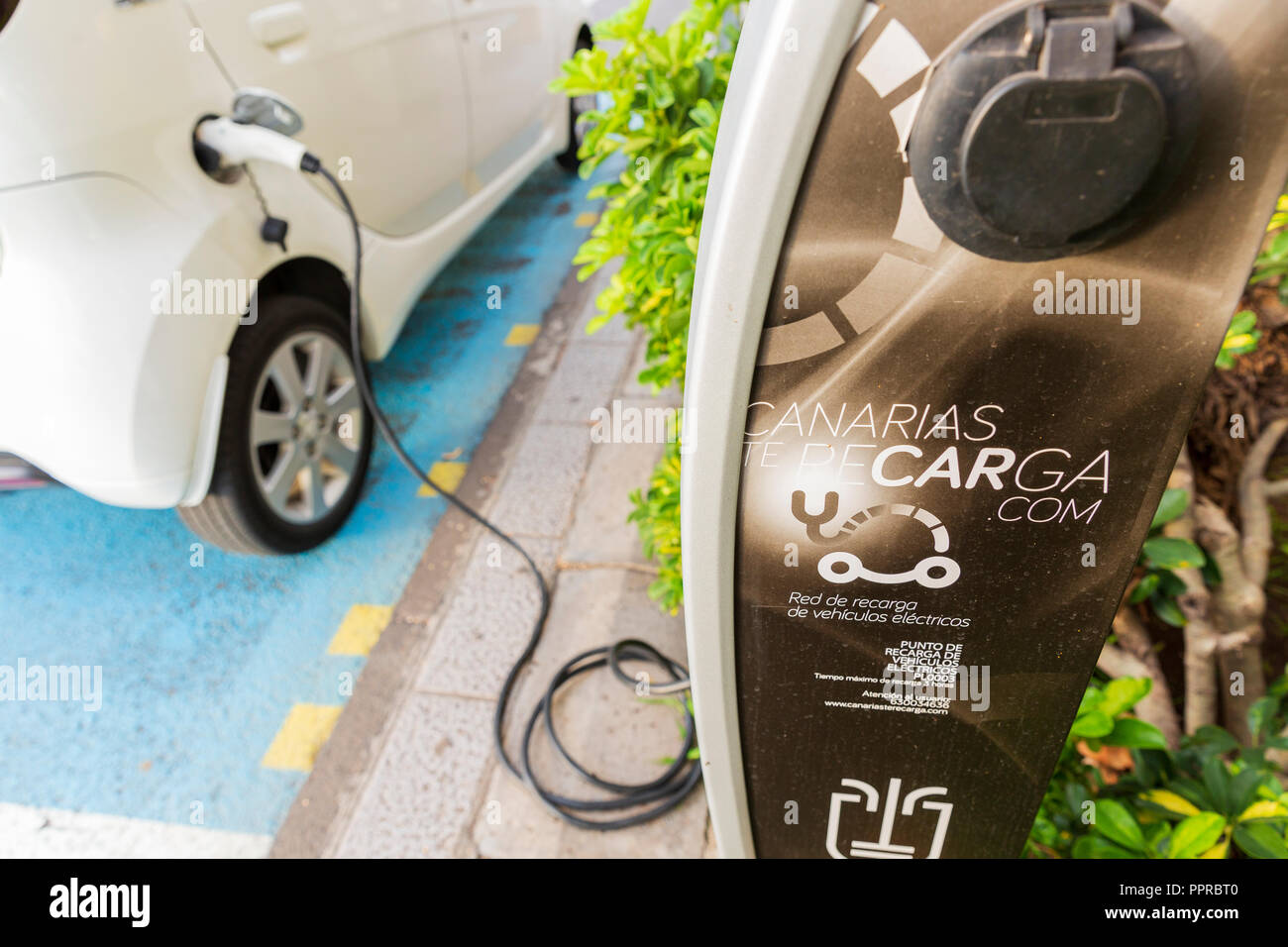 Peugeot Ion electric car plugged in at a public charging station on the street in Santa Cruz de La Palma, Canary Islands, Spain Stock Photo