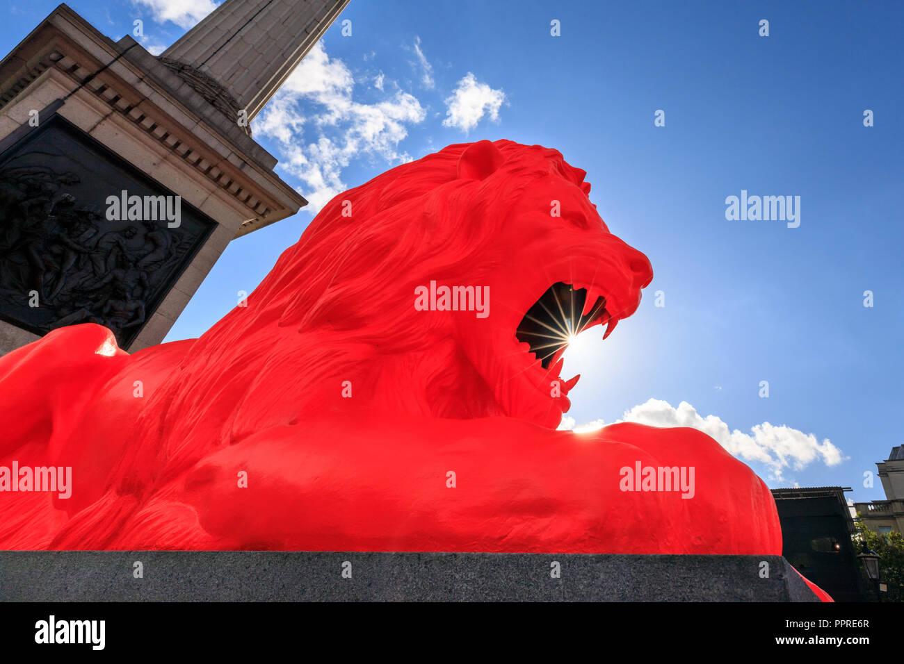 Please feed the Lions, red flurescent lion art installation by Es Devlin on Trafalgar Square, London, UK Stock Photo