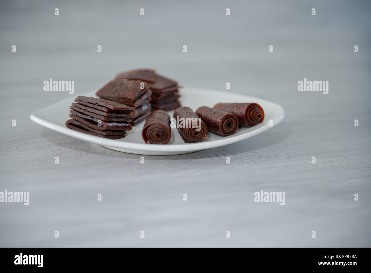 Chewing candy from sweet dough on fruit juice. Stock Photo