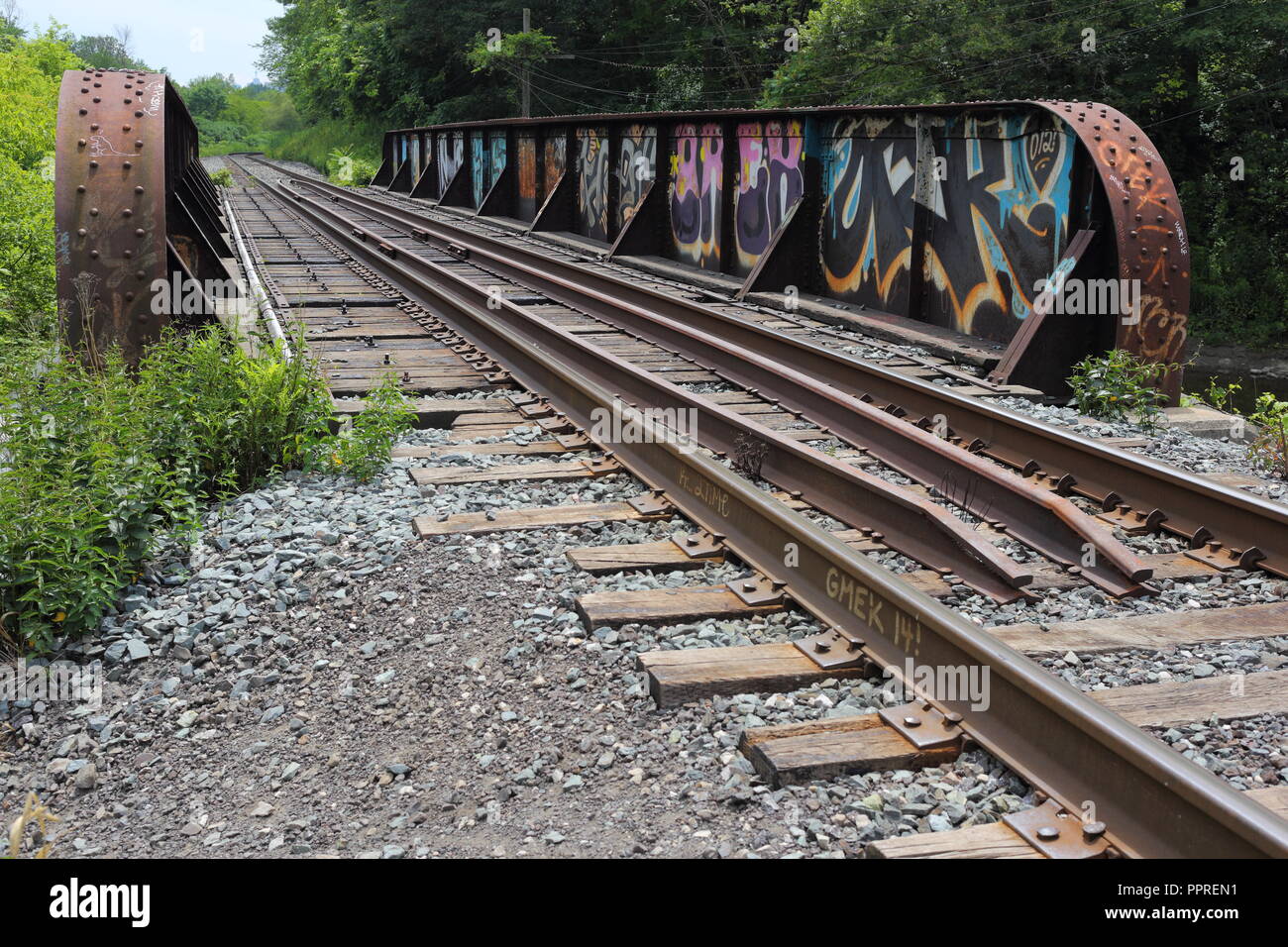 Abandoned train tracks with graffiti off of the Beltline trail in Toronto, Ontario, Canada. Stock Photo