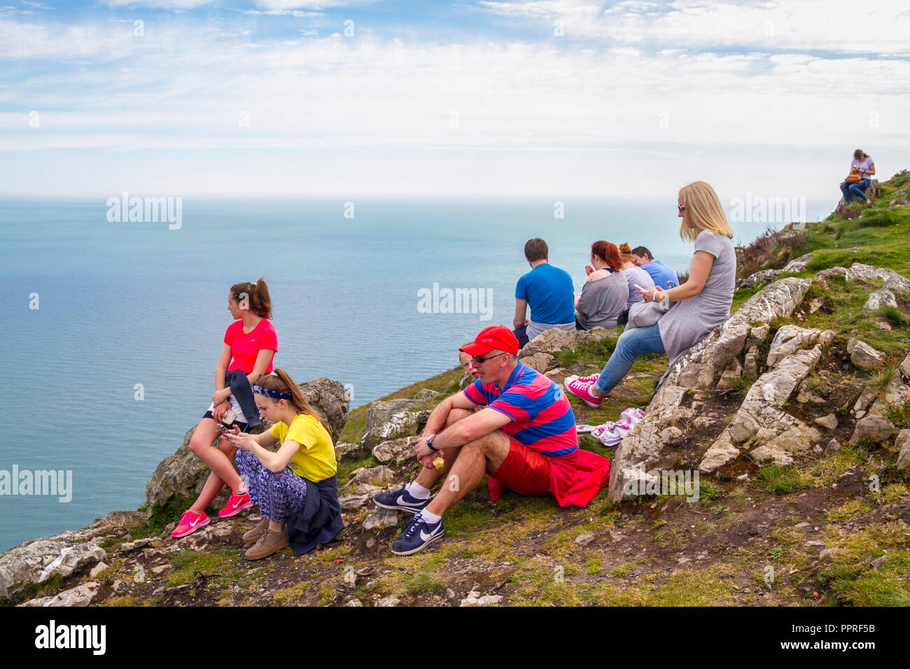 people resting during hill walk, bray head climbing wicklow Ireland Stock Photo