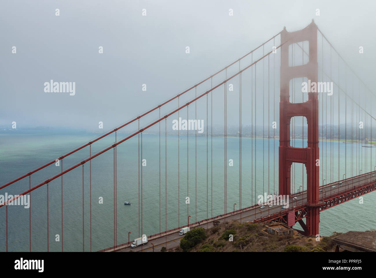 The iconic Golden Gate Bridge partially covers with fog, San Francisco