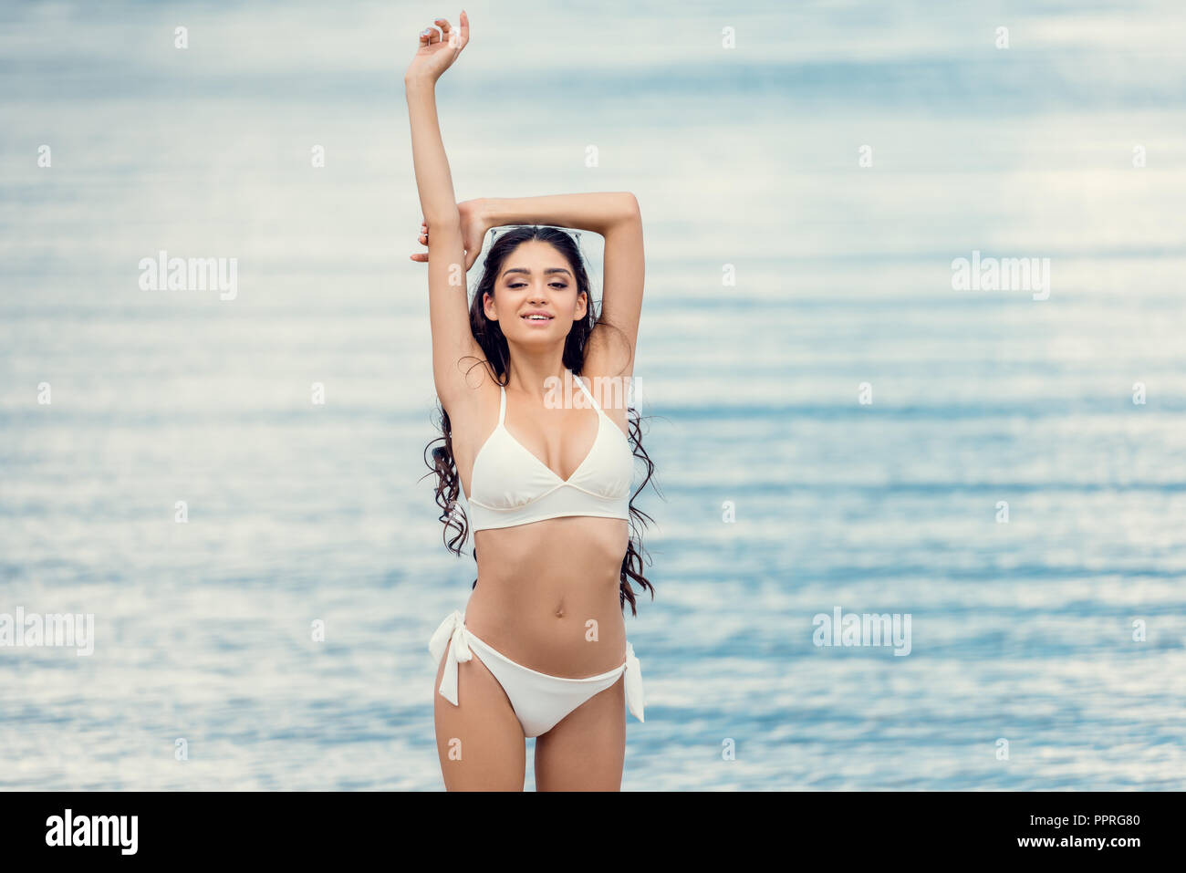 beautiful girl posing in white bikini near the sea Stock Photo Alamy