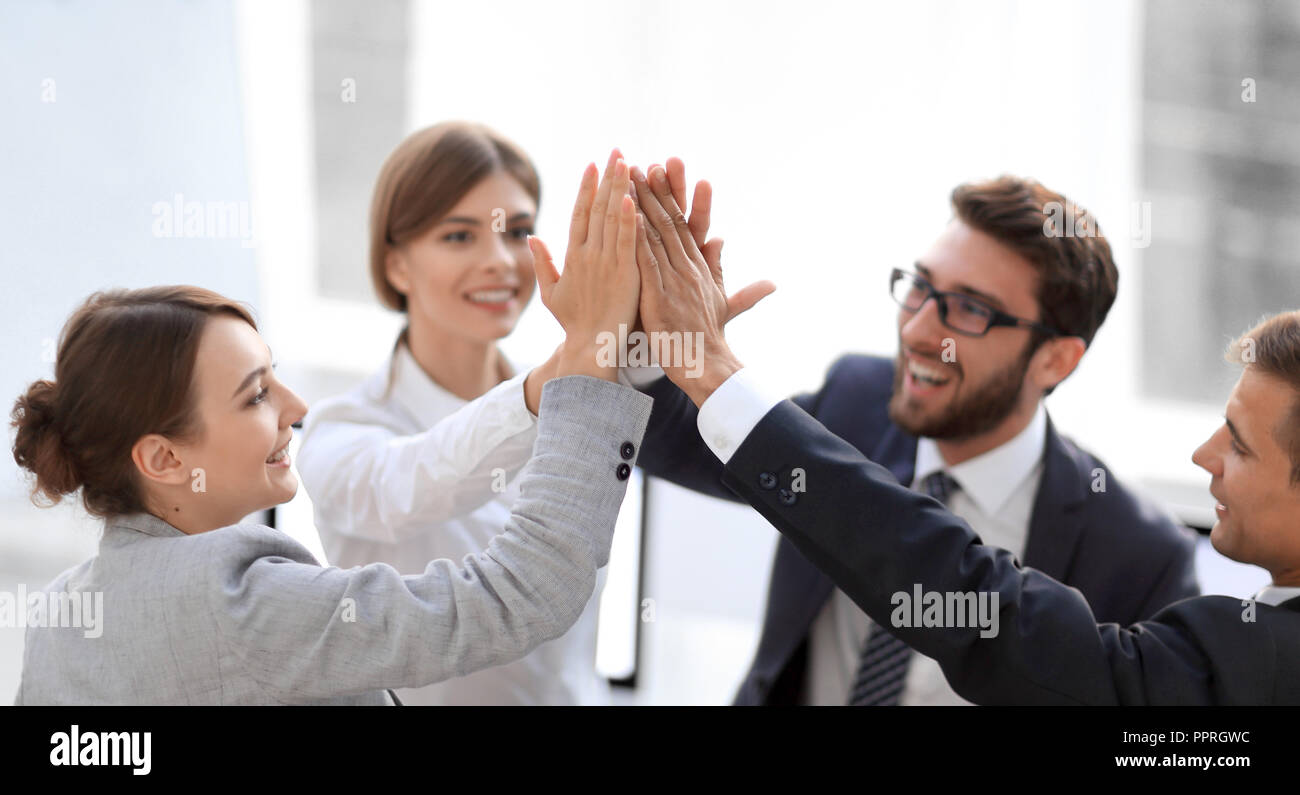 successful business team giving each other a high-five, standing in the ...