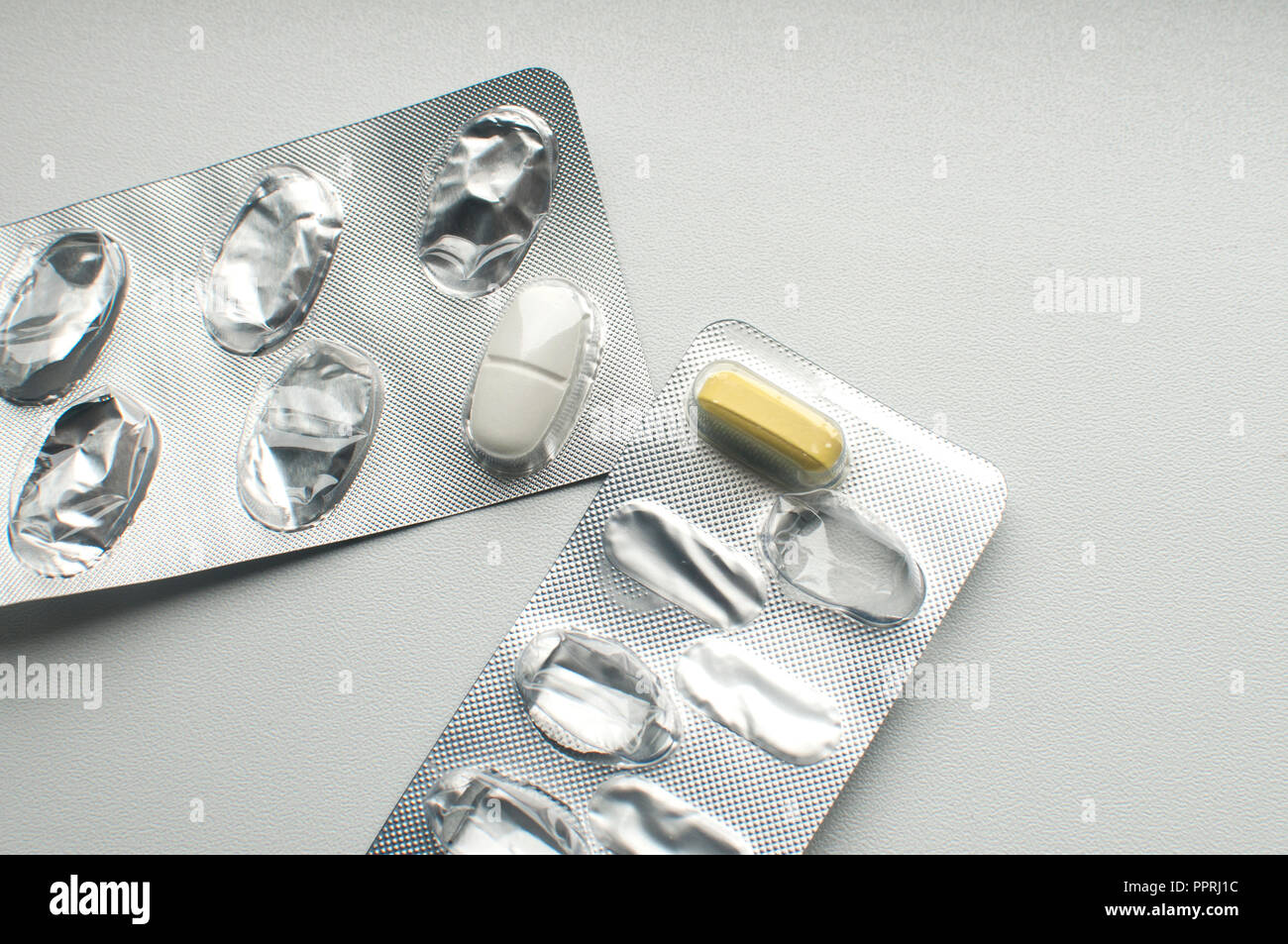 Download Left White And Yellow Pills In Used Empty Medicine Blister Packs Closeup On White Background Stock Photo Alamy PSD Mockup Templates