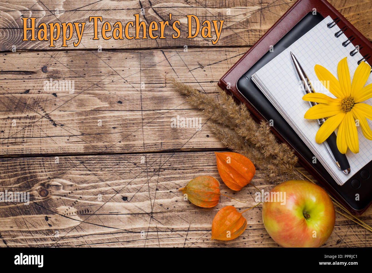 Inscription Teacher's Day. Autumn flowers and Notepad for text on ...