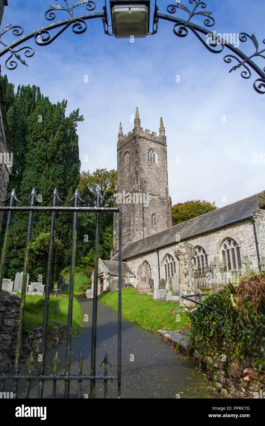 Picturesque Church of St Nonna, or the Cathedral on the Moor at Altarnun, near Bodmin, Cornwall. Viewed through the church gate with blue cloudy sky Stock Photo