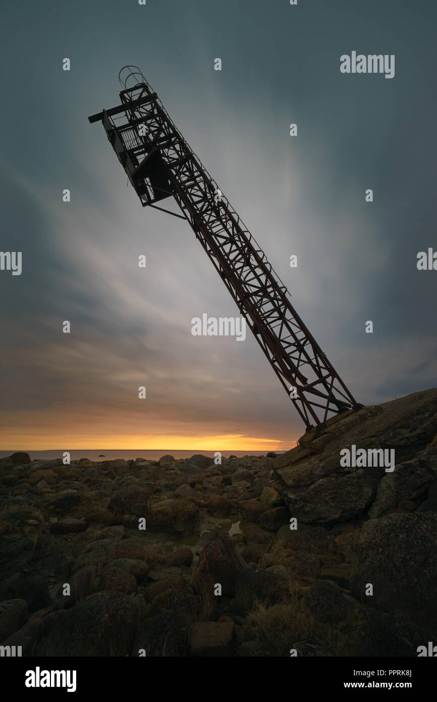 Falling tower against scenic sunrise clouds, long exposure Stock Photo