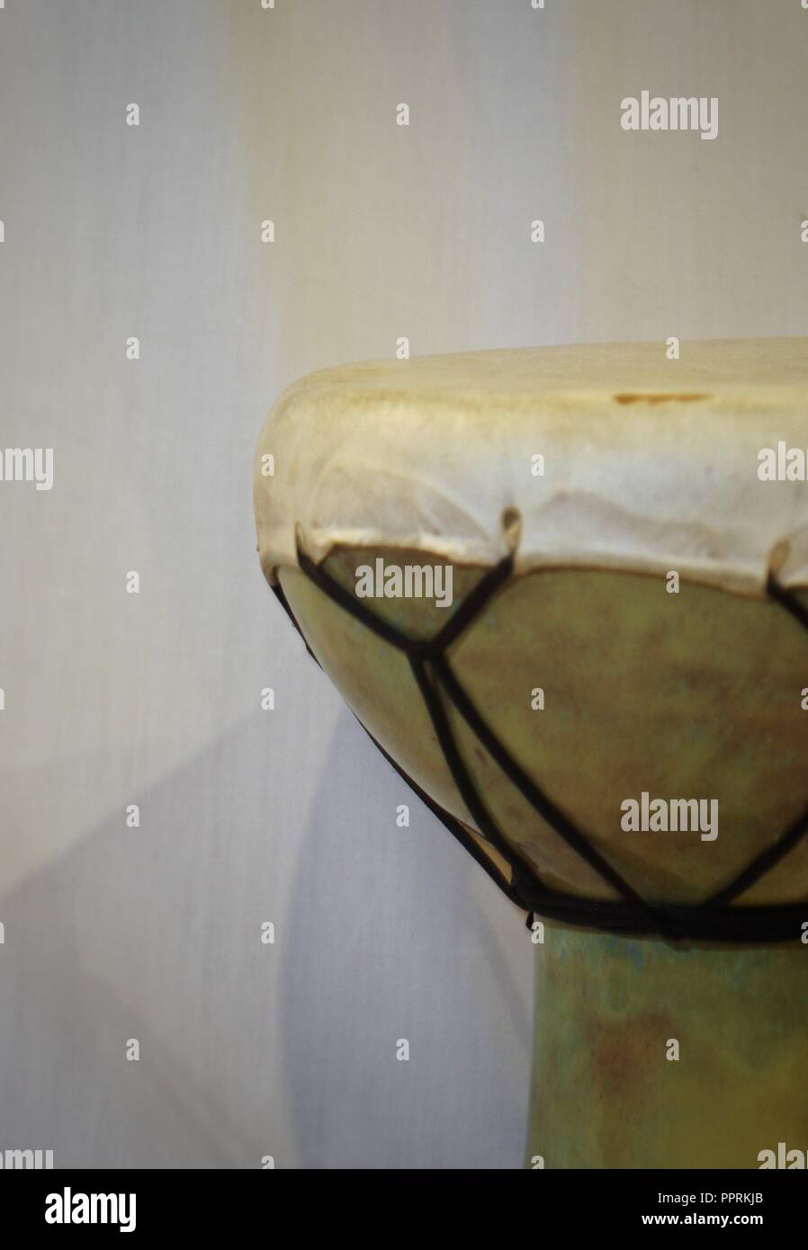 right side angle of an of an African doumbek drum against a white backdrop Stock Photo