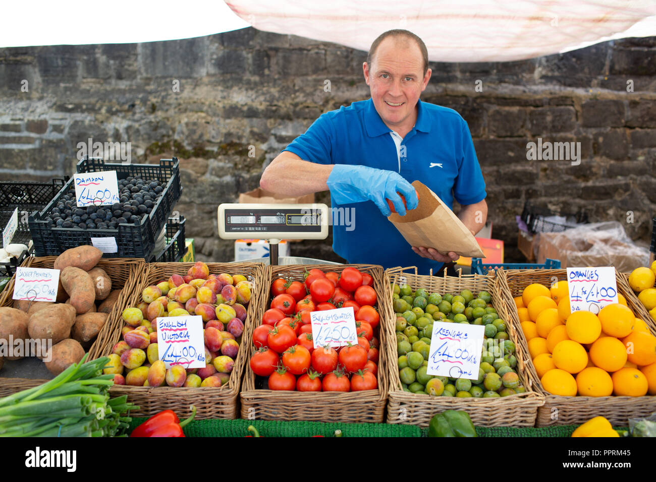 Fruit and vegetable stall holder on a market in Yorkshire . This type