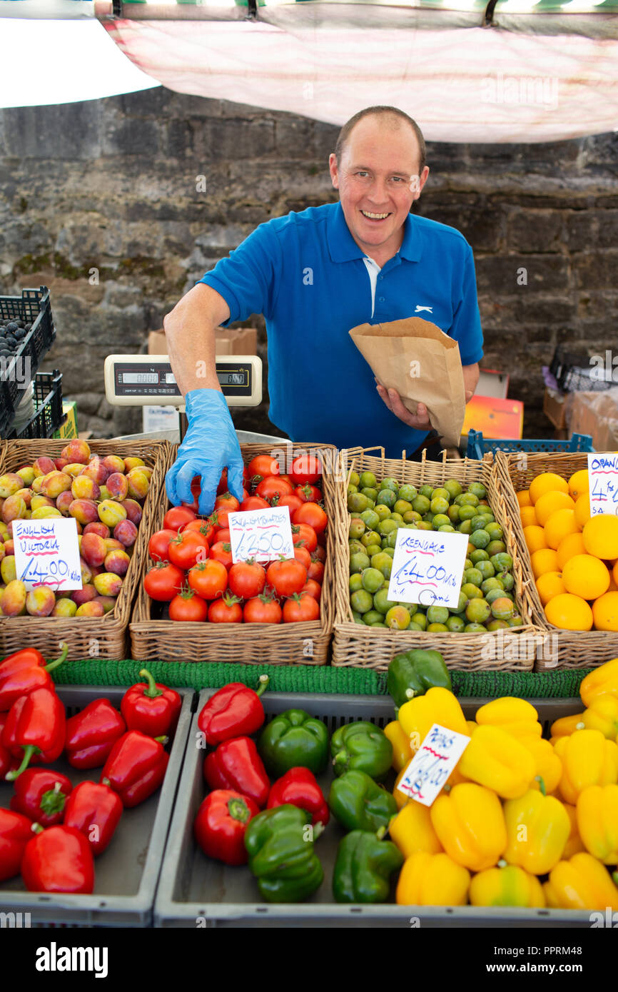 Fruit and vegetable stall holder on a market in Yorkshire . This type of retailer uses less plastic packaging on fruit and vegetables Stock Photo