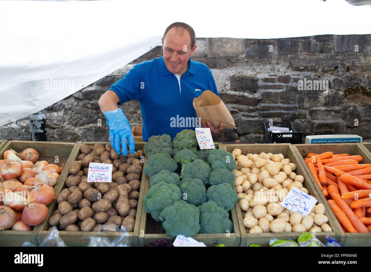 Fruit and vegetable stall holder on a market in Yorkshire . This type