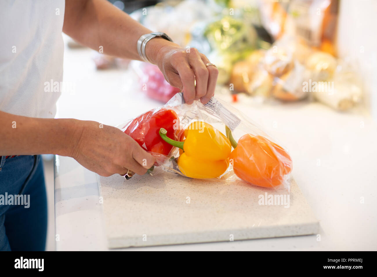 Unpacking plastic wrapped fruit and vegetables in the kitchen Plastic