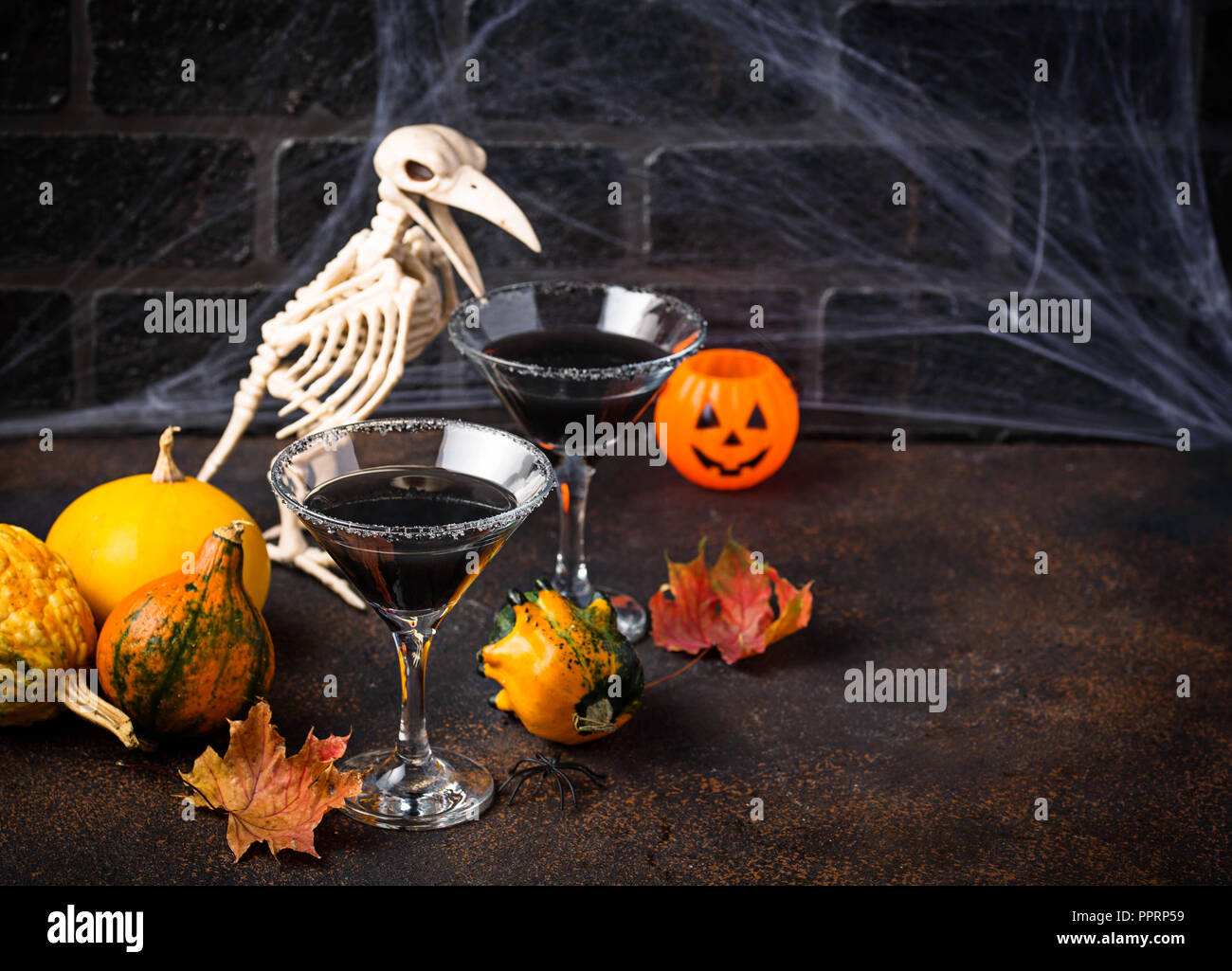 Halloweens spooky drink black martini cocktail Stock Photo Alamy
