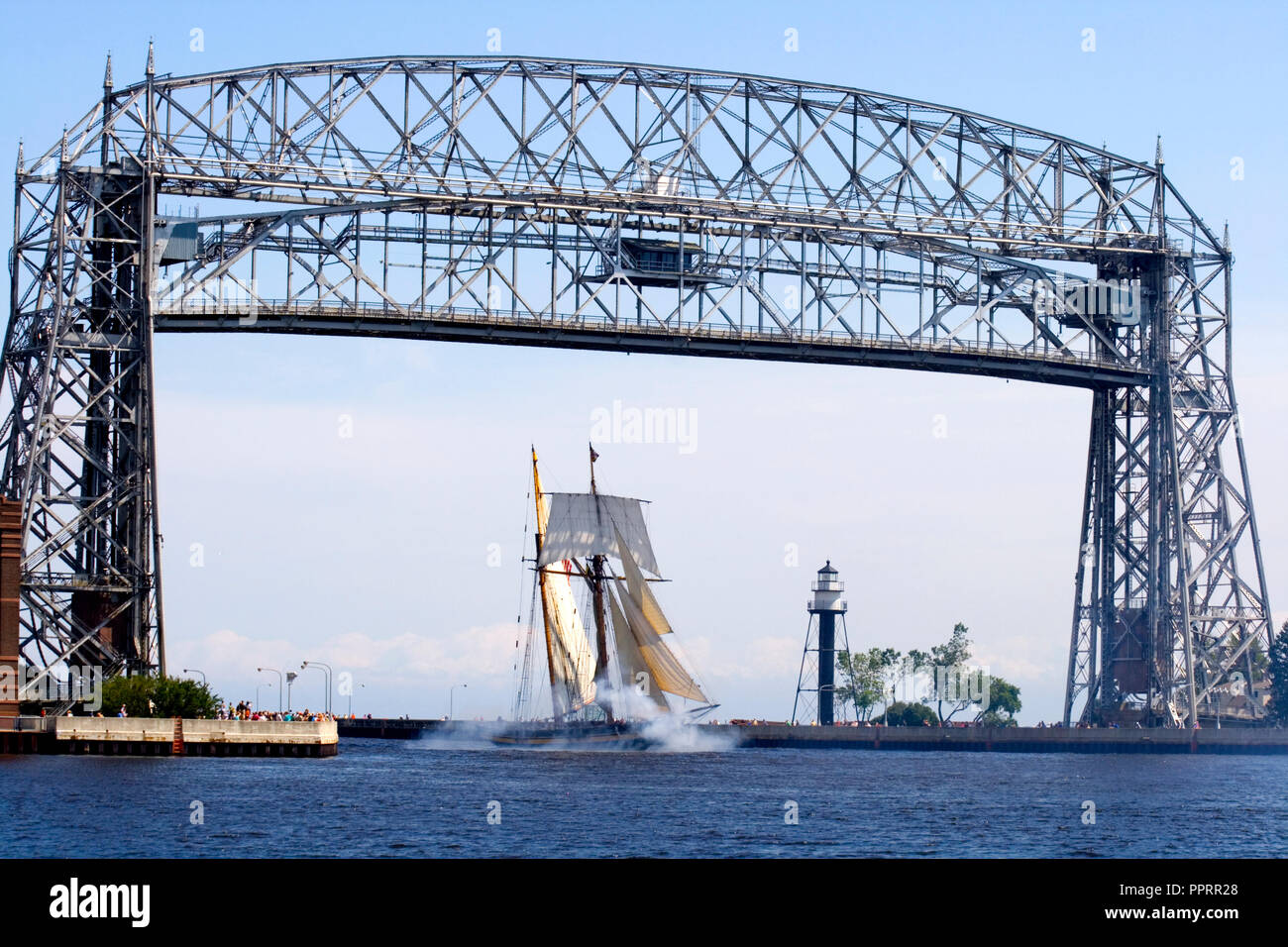 Pride of Baltimore II Tall Ship sailing under the Aerial Lift Bridge in the Duluth Port of Lake Superior Canal Park. Duluth Minnesota MN USA Stock Photo